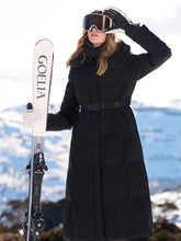 A lady wears a black coat in winter.